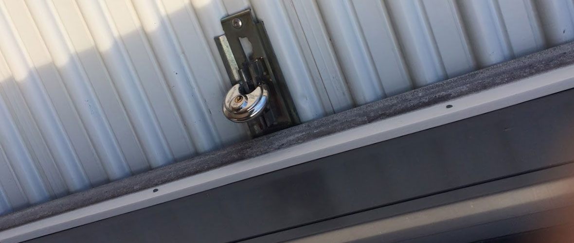 A padlock on a steel storage door